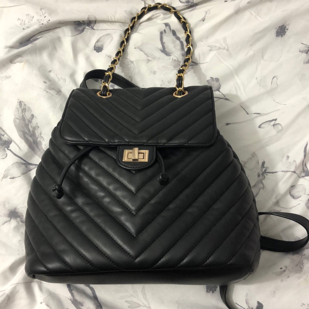 Black quilted backpack with gold hardware